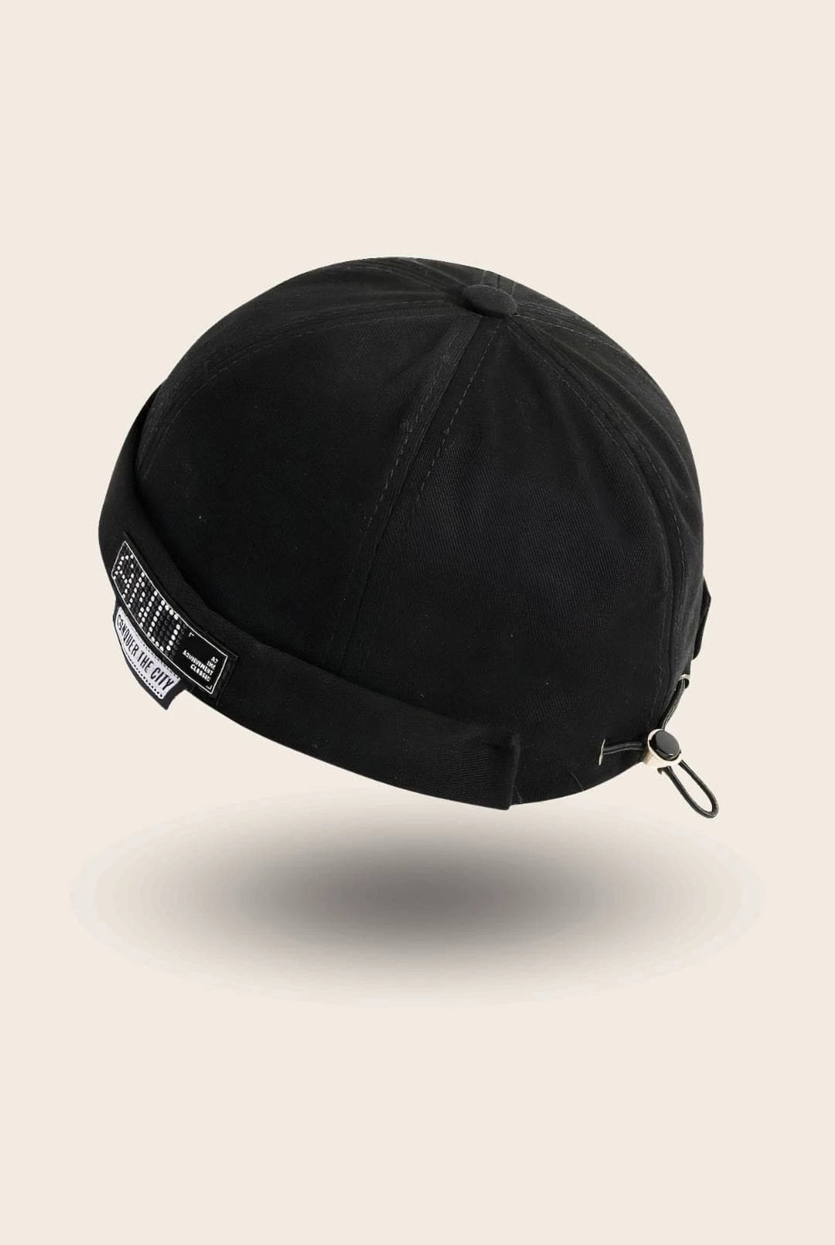 Bonnet docker And noir avec patch Conquer The City, vue de trois quarts arrière