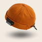 Bonnet docker And orange avec patch Conquer The City, vue de trois quarts arrière
