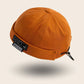 Bonnet docker And orange avec patch Conquer The City, vue de trois quarts arrière