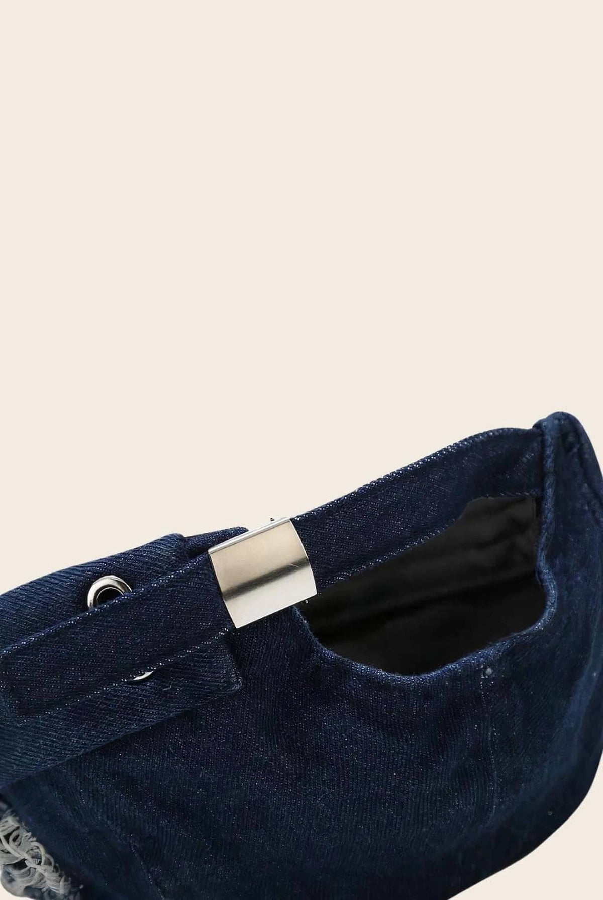 Gros plan sur la boucle de réglage du bonnet docker en Jean bleu marine
