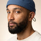 Bonnet docker Original en Coton vert foncé porté par un homme, portrait